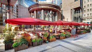 The Kempinski Hotel Corvinus Budapest with outdoor seating and potted plants. - Kempinski Hotel Corvinus Budapest (Budapest)