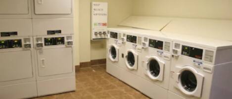 A laundry facility with multiple washing machines and dryers.