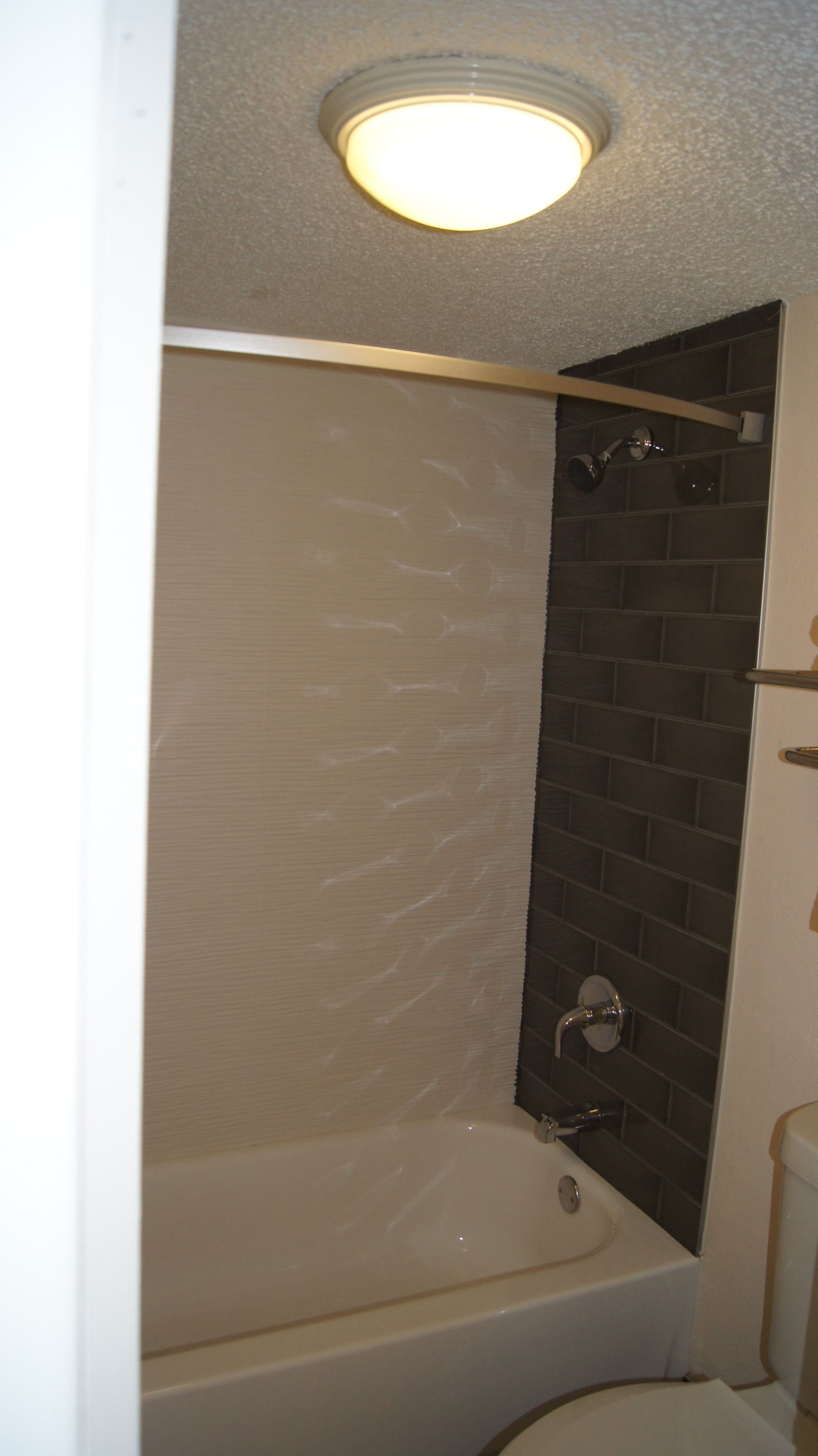 A bathroom with a bathtub, a shower, and a toilet.