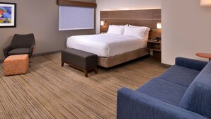 A hotel room with a large bed, a desk with a chair, a sofa, a small table, and a window with blinds. - Holiday Inn Express Walnut Creek by IHG (Walnut Creek)