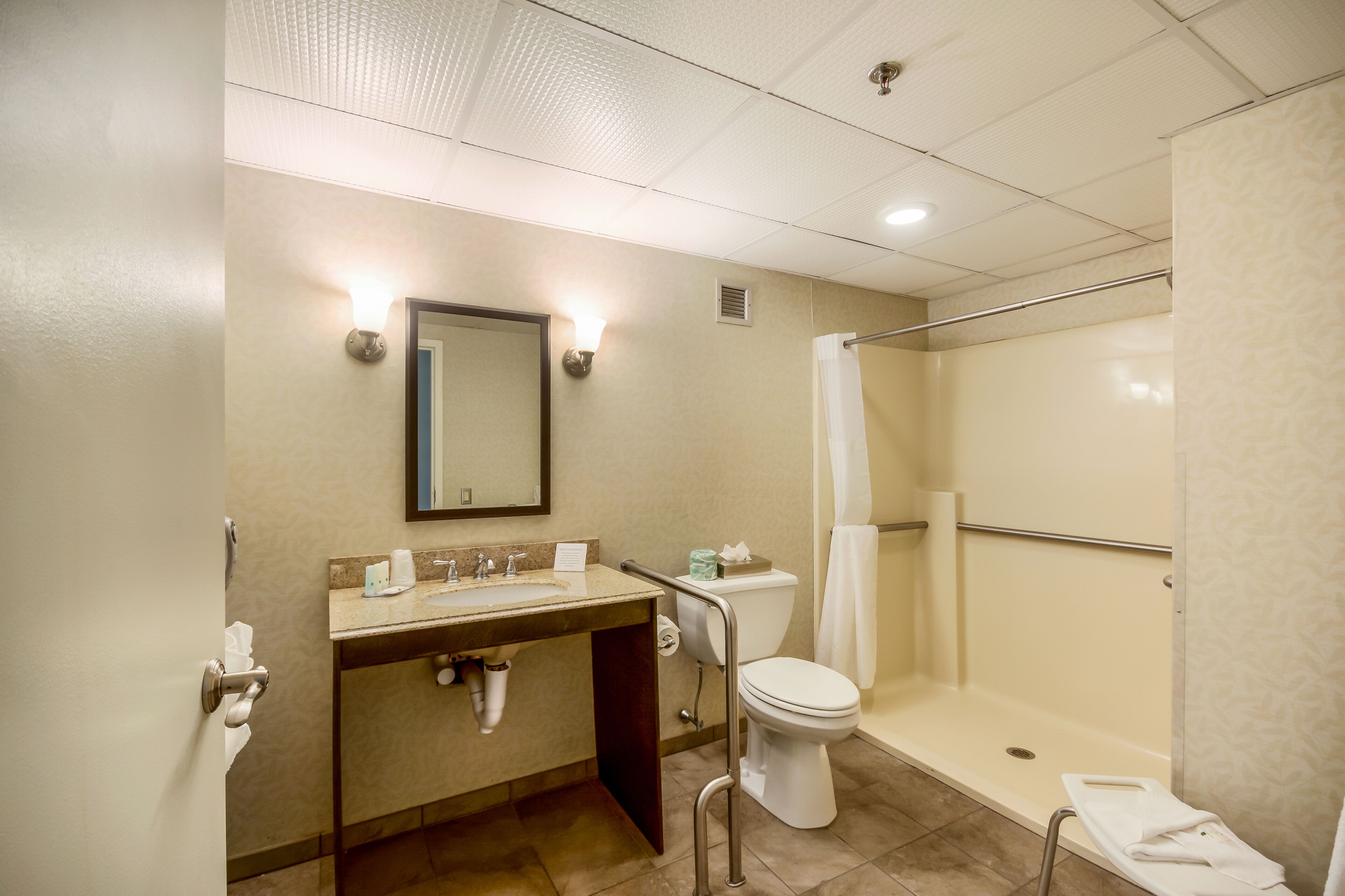 A bathroom with a sink, toilet, and shower.