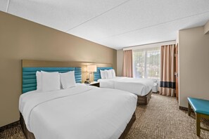 A hotel room with two beds, a desk, and a view of the outdoors. - Comfort Suites Near Gettysburg Battlefield Visitor Center (Gettysburg)