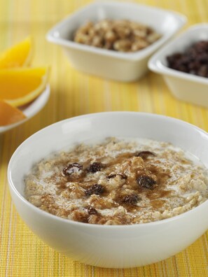 A bowl of oatmeal with raisins and cinnamon, accompanied by a plate of orange slices and two small bowls of additional food items. - Residence Inn By Marriott Atlanta Buckhead (Atlanta)