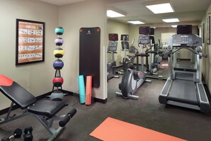 A gym with exercise equipment, a medicine ball wall chart, and a mirrored wall. - Residence Inn By Marriott Atlanta Buckhead (Atlanta)