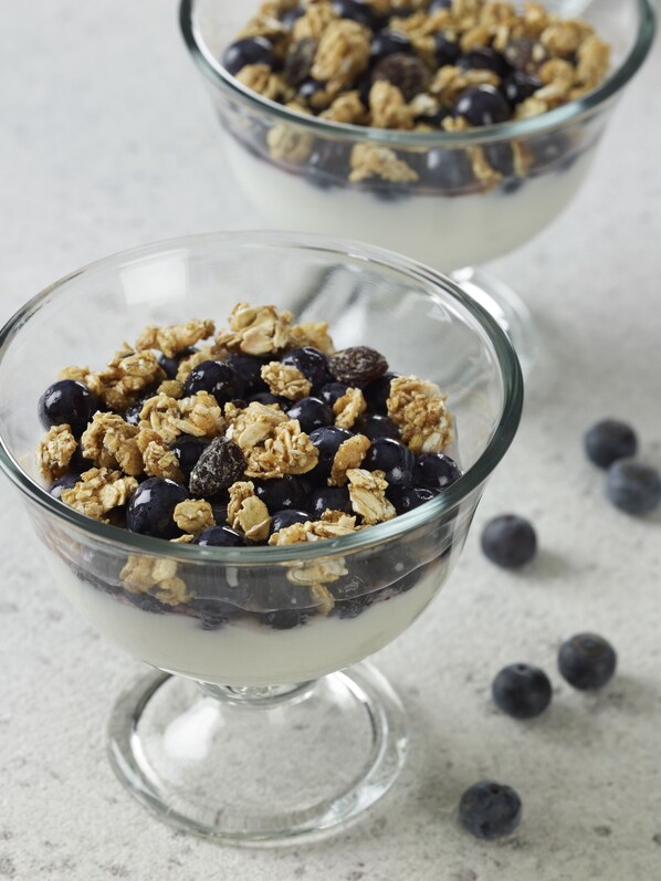 Two clear glass bowls filled with granola and blueberries, placed on a marble surface. - Residence Inn By Marriott Atlanta Buckhead (Atlanta)
