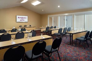 A conference room with multiple tables and chairs, a sign for Residence Inn Marriott, and large windows with blinds. - Residence Inn By Marriott Atlanta Buckhead (Atlanta)