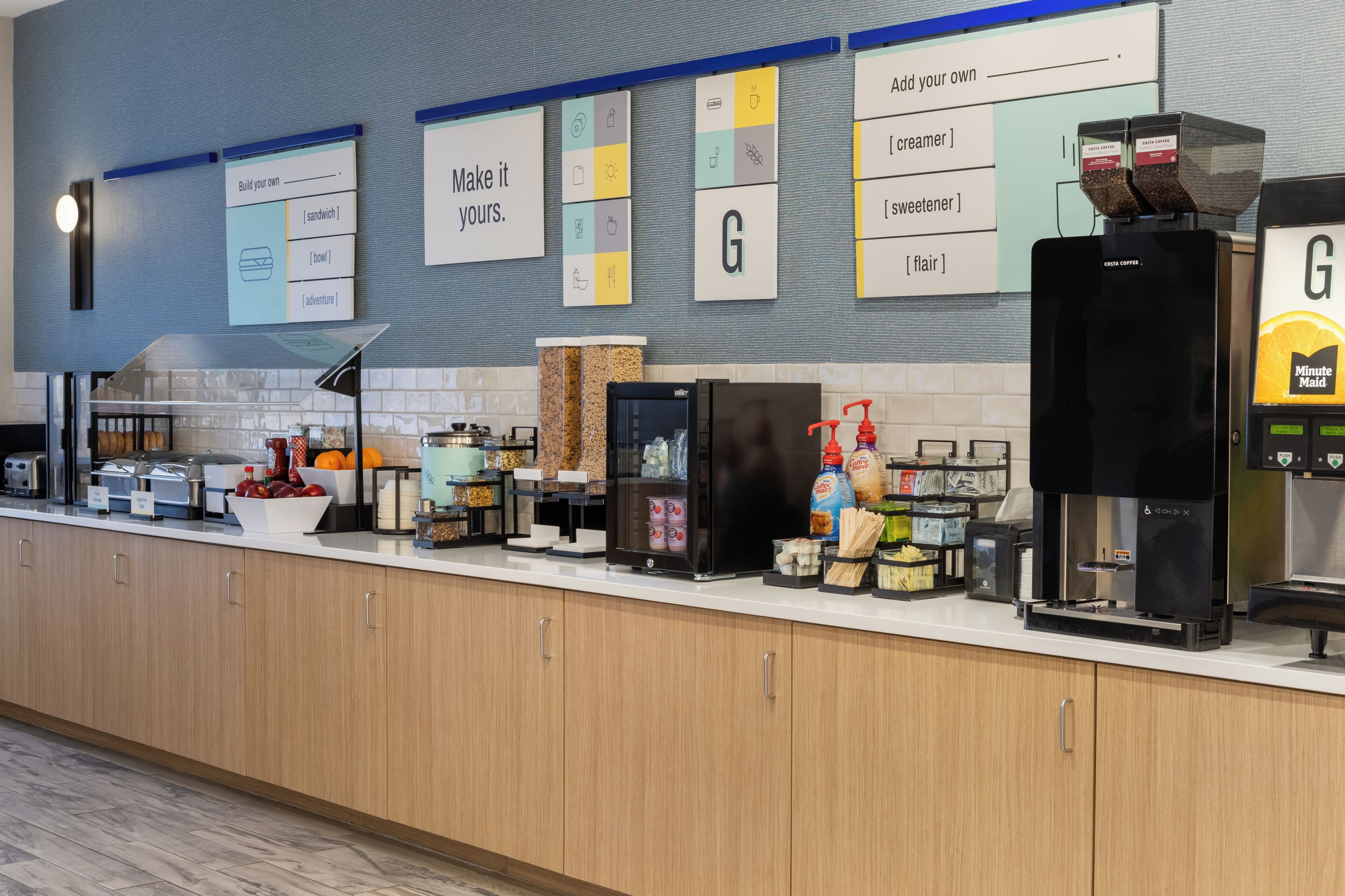 A self-service coffee station with various coffee machines, a refrigerator, and a selection of condiments and snacks.