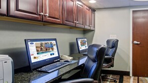 A conference room with two desktop computers, a telephone, and leather chairs. - Hampton Inn West Springfield (West Springfield)