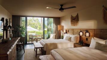 A hotel room with two beds, a desk, a chair, and a view of the outdoors.