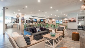 A modern lounge area with seating, a bar, and a coffee station. - Margaritaville Lake Resort Lake of the Ozarks (Osage Beach)