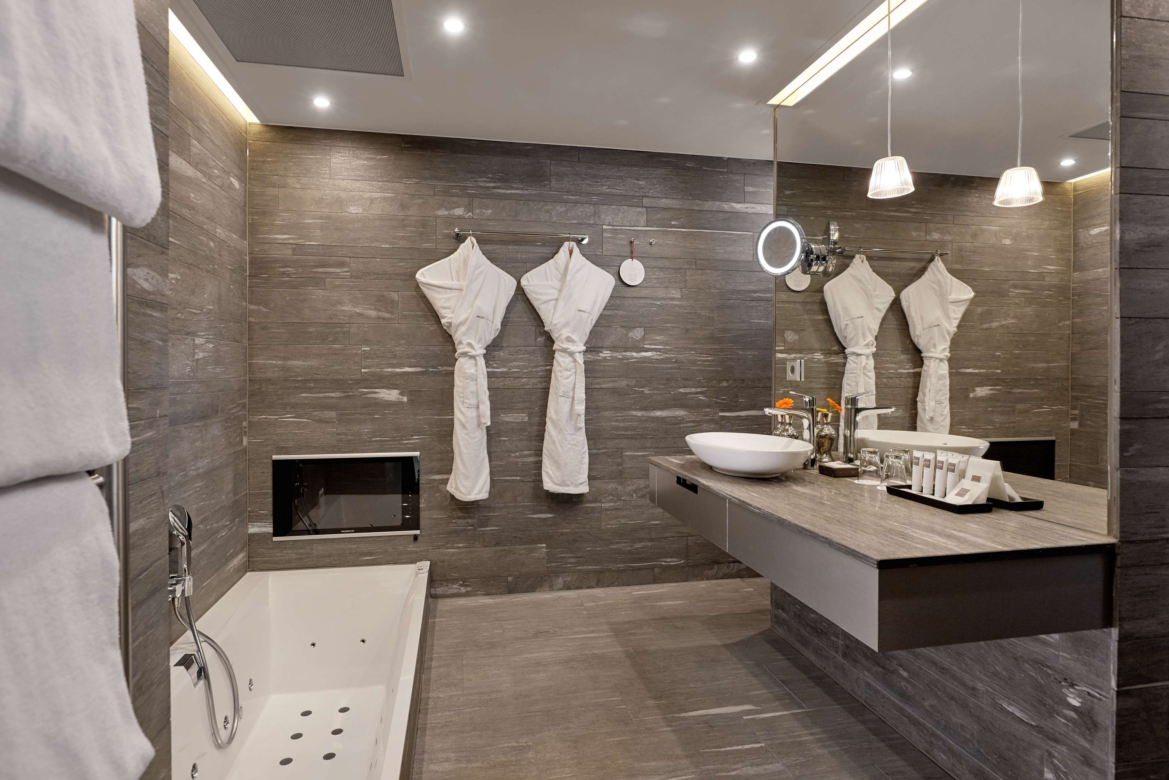 designer toiletries, hair dryer, slippers, towels