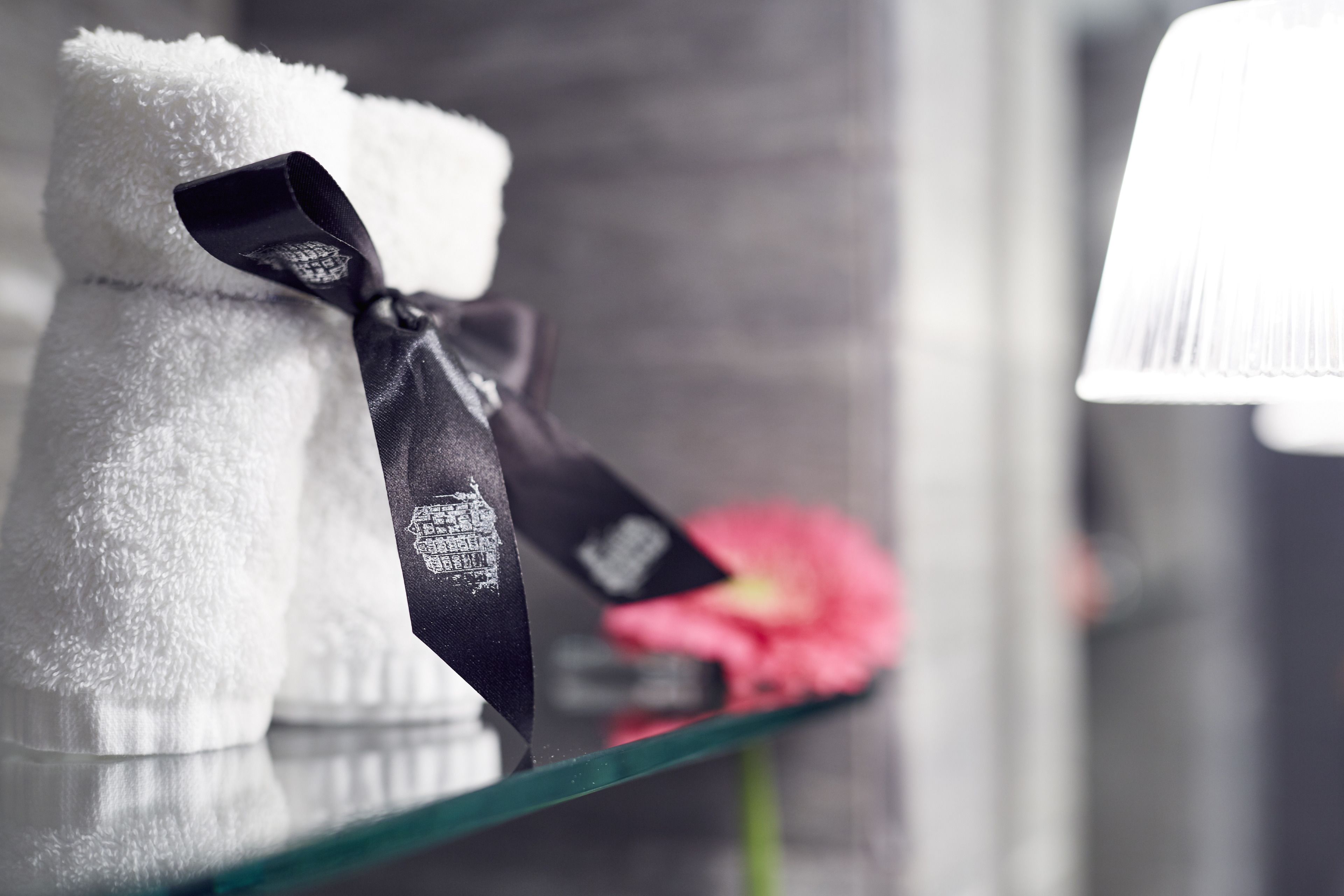 designer toiletries, hair dryer, slippers, towels