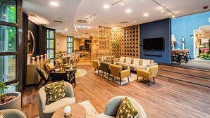 A modern lounge area with sofas, armchairs, and a dining area. - voco Vienna Prater by IHG (Vienna)