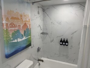 Combined shower/tub, designer toiletries, hair dryer, slippers - The Roslyn, Tapestry Collection by Hilton (Roslyn)