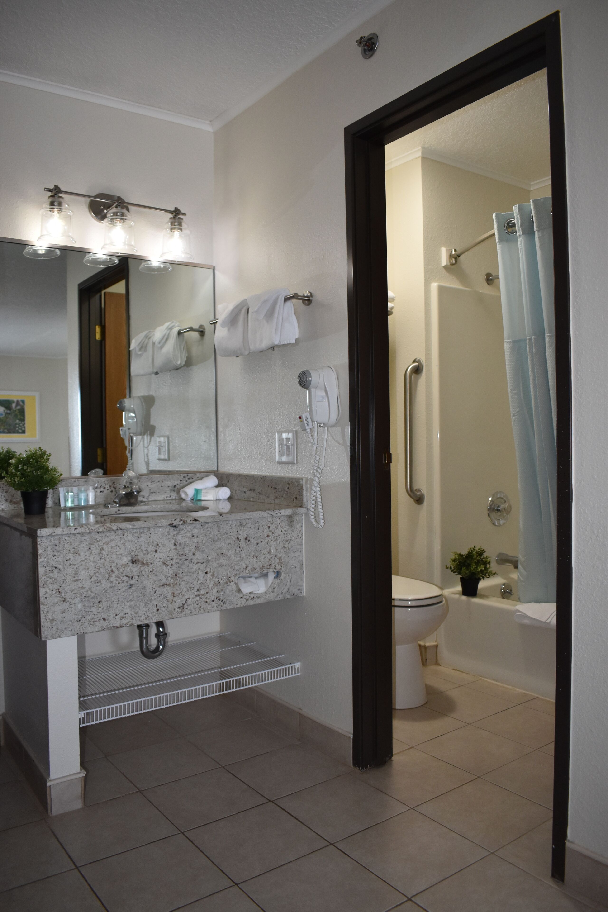 combined shower/bathtub, designer toiletries, hair dryer, towels