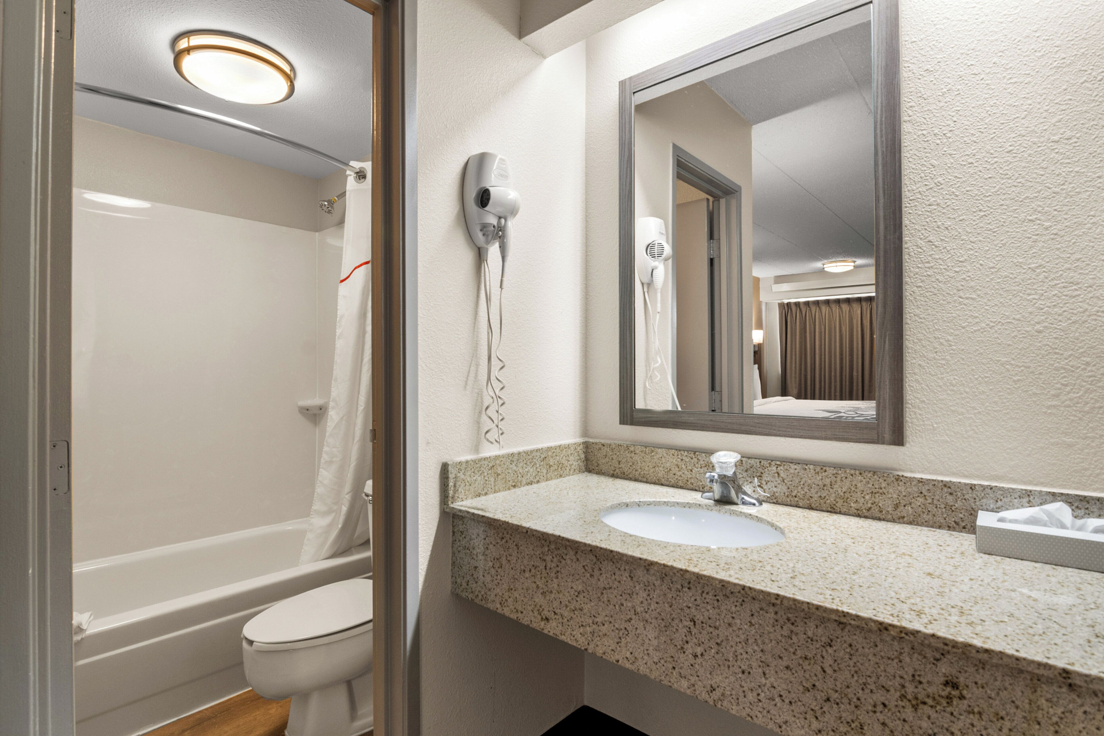 Un baño con ducha, inodoro y lavamanos.