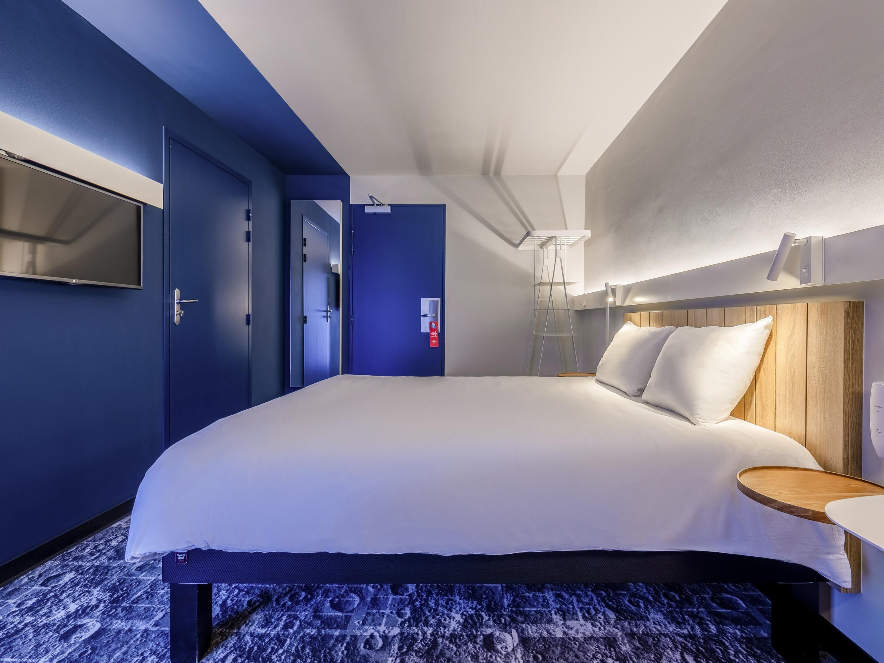 Premium bedding, desk, laptop workspace, blackout drapes