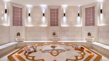 Relax in a serene space with a central seating area, two sinks, and decorative mirrors.