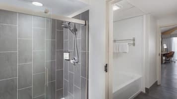 A modern bathroom with a glass-enclosed shower, a bathtub, and a walk-in shower.