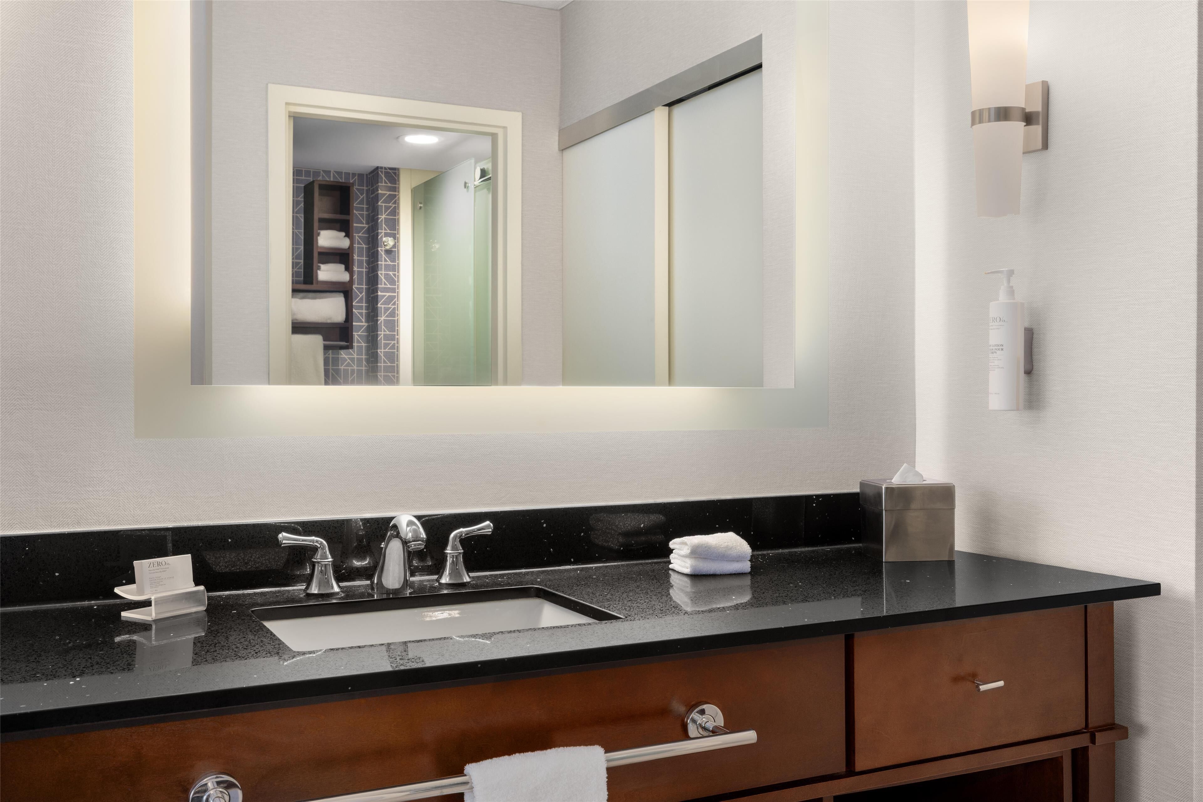 combined shower/bathtub, designer toiletries, hair dryer, towels