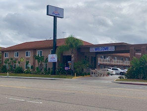 Welcome to Buena Park Inn, where guests can park their vehicles and enter through the inviting entrance.