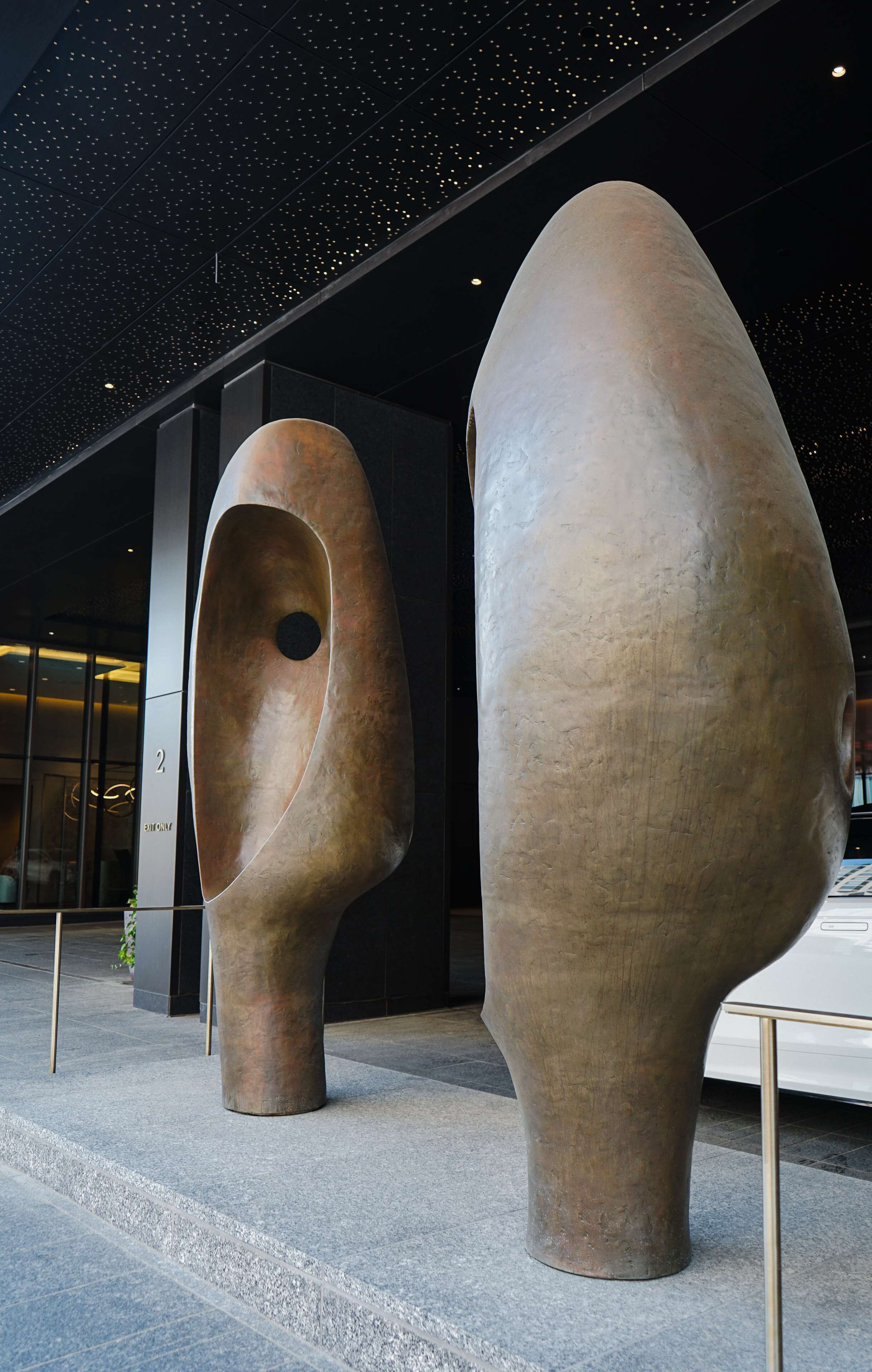 Two large, abstract sculptures in an outdoor setting.