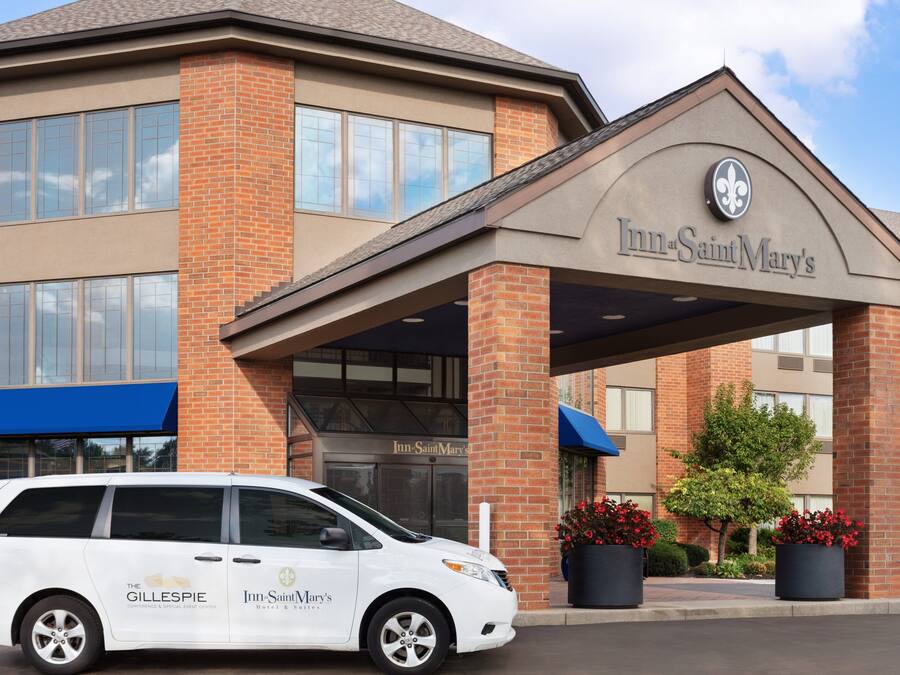 A brick building with a sign reading "Inn Saint Mary's".