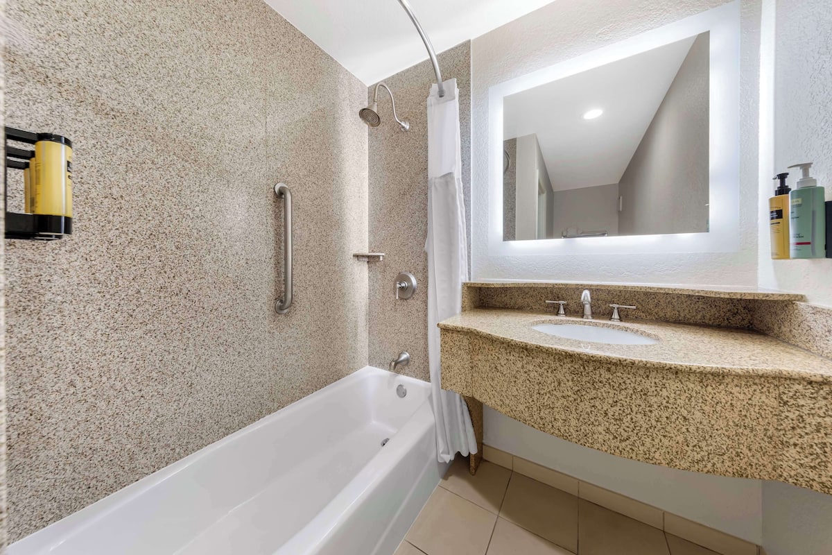 standard room, 2 queen beds, non smoking, refrigerator & microwave | bathroom | combined shower/bathtub, free toiletries, hair dryer, towels