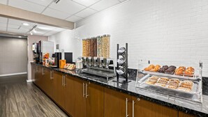 A breakfast bar with various food options, including cereal, pastries, and coffee machines. - The Penn Stroud, Stroudsburg - Poconos, an Ascend Collection Hotel (Stroudsburg)