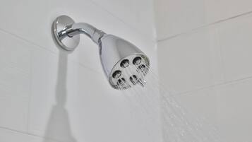 A showerhead with multiple nozzles, mounted on a wall.