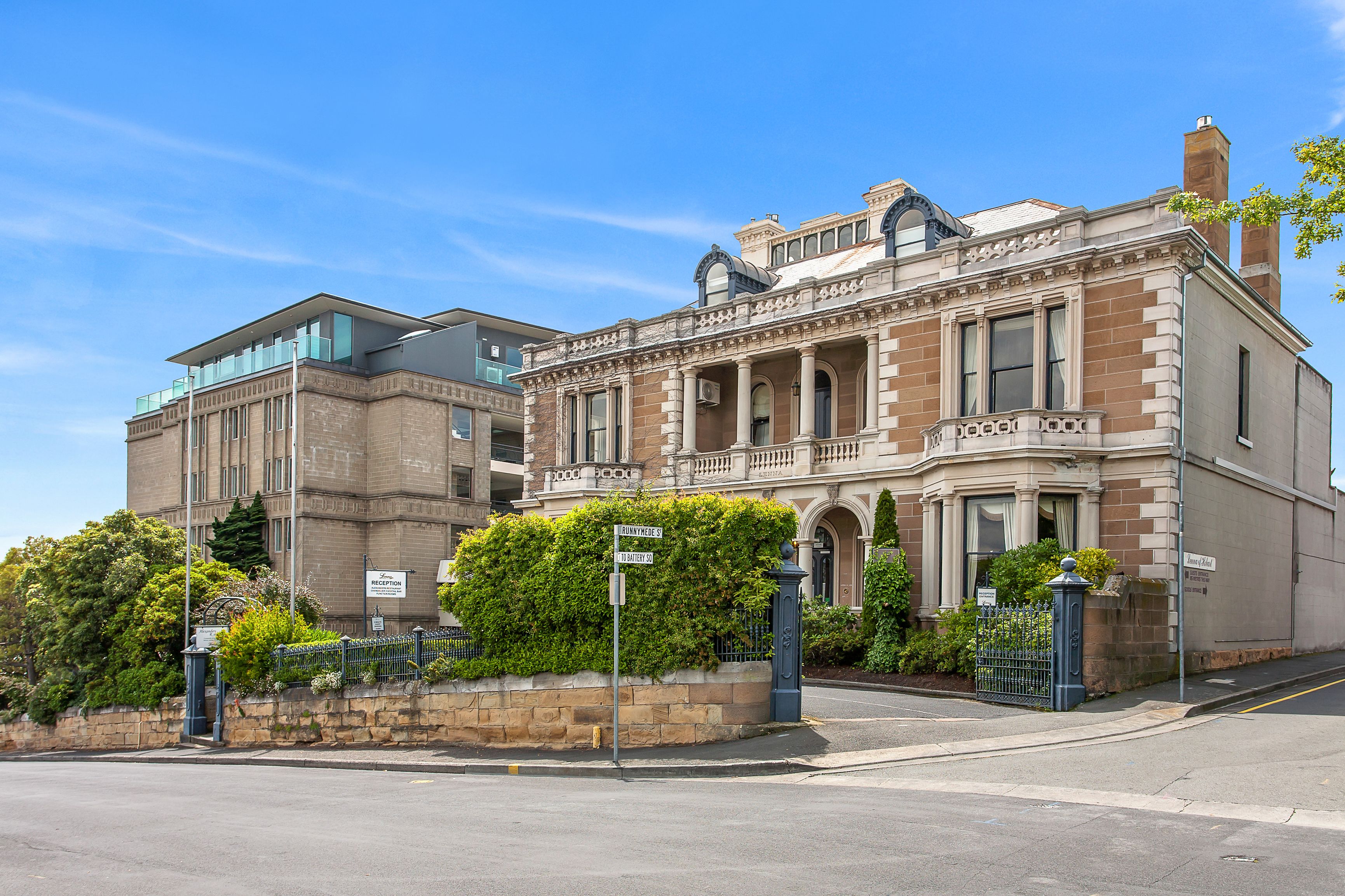 A historic building with a prominent entrance, large windows, and a stone facade.