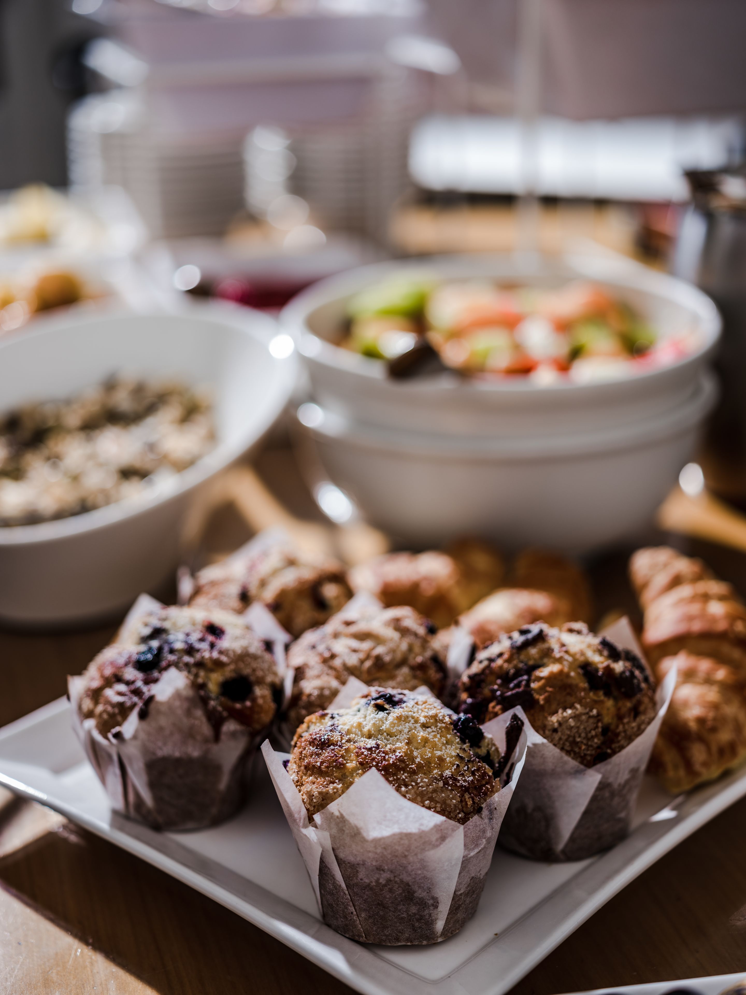 A table with various food items including pastries and a salad.