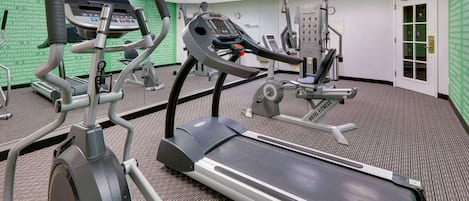 A fitness center with treadmills, elliptical machines, and weight equipment.