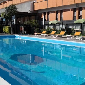 Piscine extérieure, parasols de plage, chaises longues