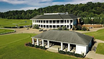 Situated on a well-maintained lawn, this clubhouse offers a covered area for gatherings and events, surrounded by a fence and accessible by vehicle.