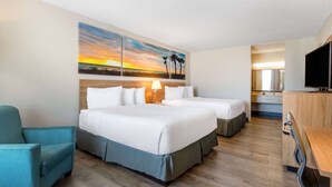 A hotel room with a large bed, a desk, a chair, and a television. - Days Inn by Wyndham Titusville Kennedy Space Center (Titusville)