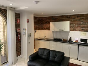 Suite 40 - 1 Bedroom with Kitchenette  | Living area | 32-inch LCD TV with premium TV channels, TV, iPod dock
