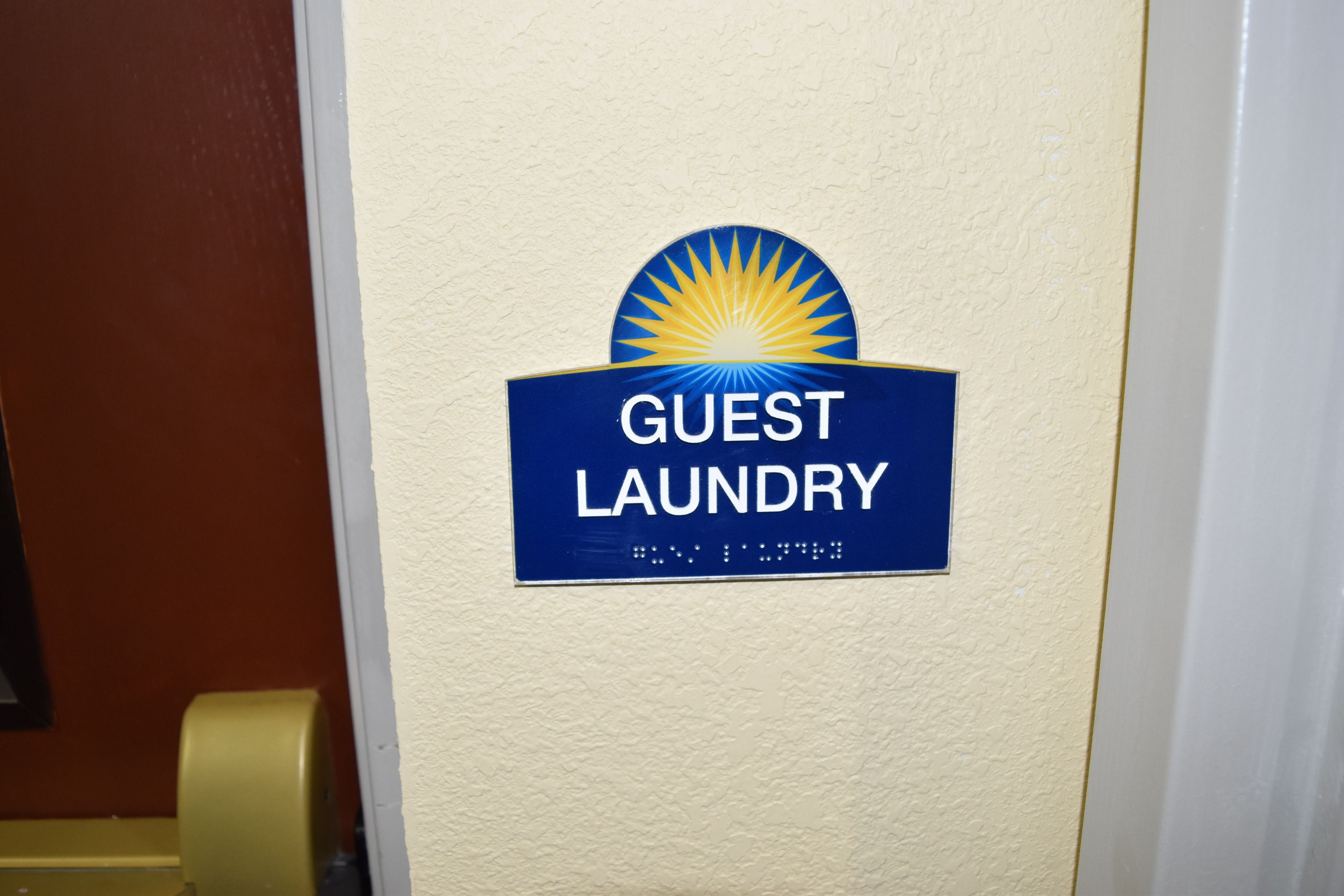 A wall-mounted sign indicating a guest laundry facility.
