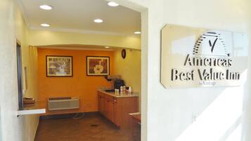 A reception area with a sign indicating it's the Americas Best Value Inn by Vantage.