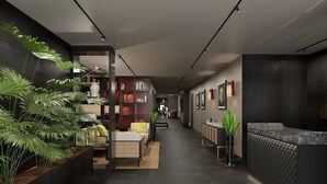 A modern reception area with a reception desk, seating area, and a bookshelf. - Universo And Nord Hotel (Venice)