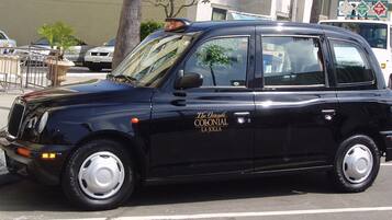A black taxi with "The Grande Colonial La Jolla" written on its side.