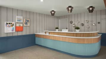 A reception desk with a blue and wooden design, a plant, and wall-mounted decorative plates.