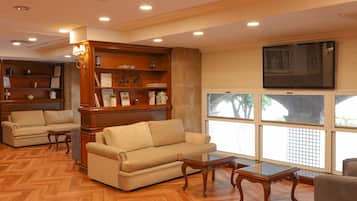 A living room with a sofa, a coffee table, and a bookshelf.
