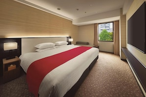Relax in a stylish room with a large bed, flat-screen TV, and city views.