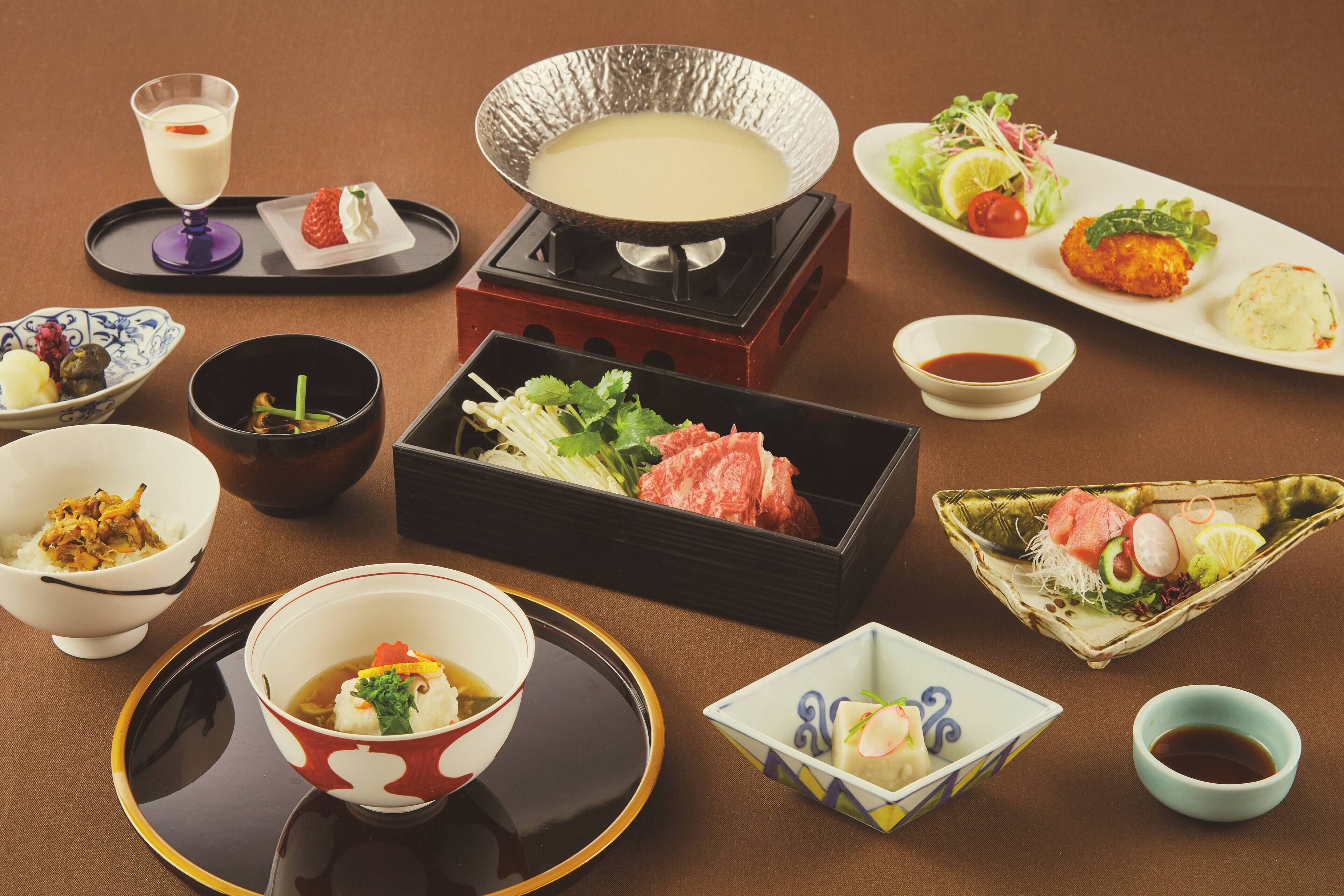 A variety of Japanese dishes including sushi, sashimi, and a hot pot setup.