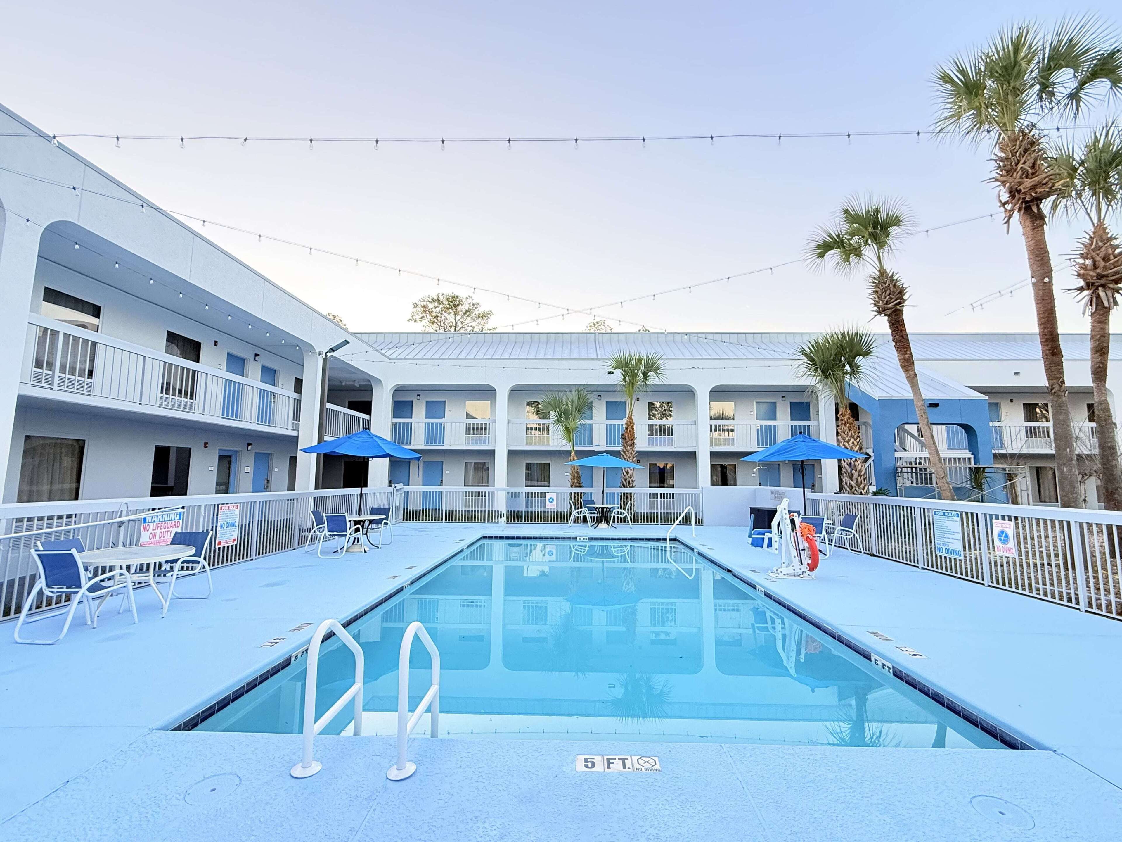 Outdoor pool, open 8 AM to 8:00 PM, pool umbrellas