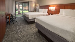 A hotel room with two beds, a desk, and a view of the outdoors. - Sonesta Select Seattle Bellevue Redmond (Bellevue)