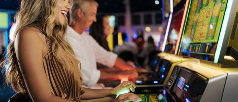 A slot machine with illuminated reels and a digital display.