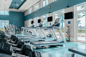 A gym with treadmills, dumbbells, and exercise equipment. - Hilton Aruba Caribbean Resort and Casino (Noord)