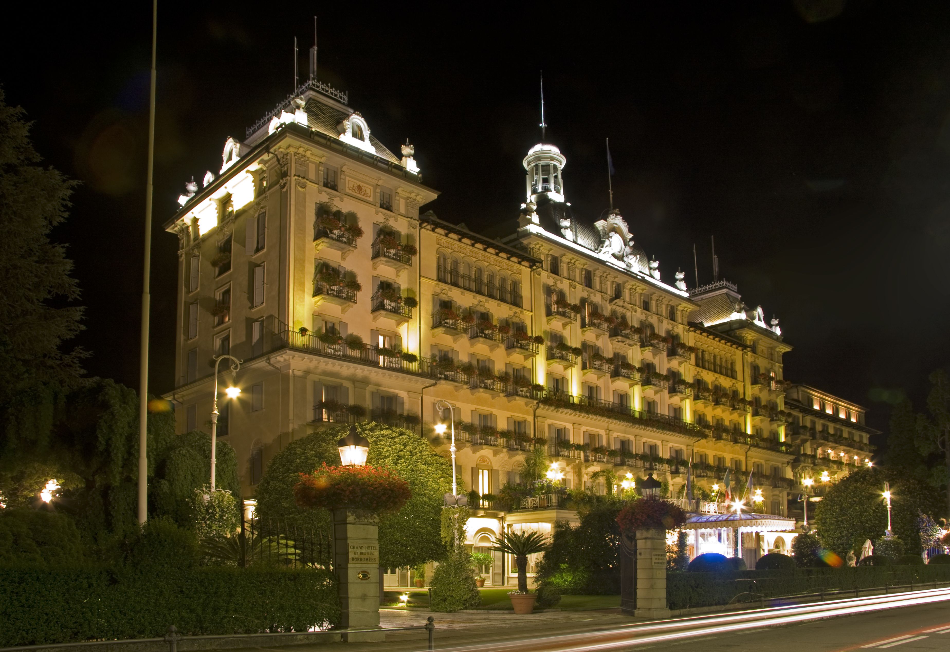 A large, multi-story hotel with a classic European architectural style, featuring balconies and ornate detailing.